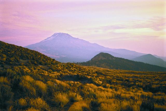 Distant Mount Iztaccihuatl seen from the high slopes of Mount Popocatepetl in Mexico